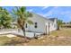 Charming home exterior with a deck, palm tree, and well-maintained yard, showcasing curb appeal at 725 Avenue B Sw, Winter Haven, FL 33880