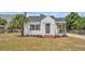 Charming home exterior with a well-manicured lawn and a welcoming front porch, showcasing classic curb appeal at 725 Avenue B Sw, Winter Haven, FL 33880