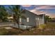 Charming home exterior with a deck, palm tree, and well-maintained yard, showcasing curb appeal at 725 Avenue B Sw, Winter Haven, FL 33880