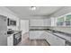 Bright kitchen featuring white cabinets, stainless steel appliances, and modern countertops at 725 Avenue B Sw, Winter Haven, FL 33880