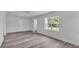 Bright living space featuring wood-look floors and a clear view of the home's entrance at 725 Avenue B Sw, Winter Haven, FL 33880