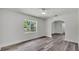 Light-filled living room with gray flooring, neutral walls, and archway at 725 Avenue B Sw, Winter Haven, FL 33880