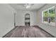 Bright living area featuring modern gray flooring and an archway to the kitchen at 725 Avenue B Sw, Winter Haven, FL 33880