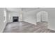 Spacious living room featuring a fireplace and modern gray flooring at 725 Avenue B Sw, Winter Haven, FL 33880