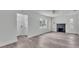 Open-concept living room with a fireplace and wood-look flooring at 725 Avenue B Sw, Winter Haven, FL 33880
