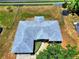 An aerial view of home highlights the roof and backyard space with fencing and a trampoline at 790 Chelsea Way, Lake Wales, FL 33853