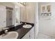Bathroom featuring a double sink vanity with dark countertops, and a shower with a glass door at 790 Chelsea Way, Lake Wales, FL 33853
