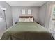 Comfortable bedroom with tiled floor and bright white curtains, large bed with decorative pillows at 790 Chelsea Way, Lake Wales, FL 33853
