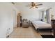 A secondary bedroom featuring a bed, ceiling fan, and a sitting area, ideal for relaxation at 790 Chelsea Way, Lake Wales, FL 33853