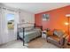 Cozy bedroom featuring a twin bed, comfortable armchair, and an abundance of natural light at 790 Chelsea Way, Lake Wales, FL 33853