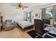 Bedroom with comfortable bed, desk, and cozy armchair, providing a relaxing and functional space at 790 Chelsea Way, Lake Wales, FL 33853
