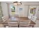 Bright dining area features a wooden table with seating for six and sliding glass doors to the patio at 790 Chelsea Way, Lake Wales, FL 33853