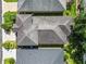 Bird's-eye view of a home with a gray roof, set amidst lush landscaping and neighboring residences at 843 Christina Chase Dr, Lakeland, FL 33813