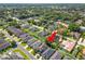 An expansive aerial shot of a residential area surrounded by trees, featuring spacious homes and verdant lawns at 843 Christina Chase Dr, Lakeland, FL 33813
