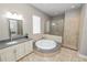 Large ensuite bathroom with soaking tub and glass enclosed shower at 843 Christina Chase Dr, Lakeland, FL 33813