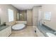 Large ensuite bathroom with soaking tub, glass enclosed shower and dual sinks at 843 Christina Chase Dr, Lakeland, FL 33813