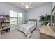 Bright bedroom with a ceiling fan and a large window overlooking the yard at 843 Christina Chase Dr, Lakeland, FL 33813