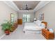 Bedroom featuring neutral colors, tray ceilings, ceiling fan and plenty of natural light at 843 Christina Chase Dr, Lakeland, FL 33813
