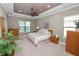 Bedroom featuring neutral colors, tray ceilings, ceiling fan and plenty of natural light at 843 Christina Chase Dr, Lakeland, FL 33813
