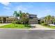 Two-story home with paver driveway, lush landscaping, and a welcoming facade at 843 Christina Chase Dr, Lakeland, FL 33813