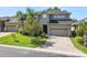 Stunning two-story home with a green lawn, mature trees, and an attached two-car garage at 843 Christina Chase Dr, Lakeland, FL 33813