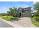 Charming two-story home with a manicured front yard and a brick-paved driveway at 843 Christina Chase Dr, Lakeland, FL 33813