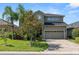 Two-story home with paver driveway, lush landscaping, and a welcoming facade at 843 Christina Chase Dr, Lakeland, FL 33813