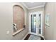 Foyer with decorative alcove, transom window, and glass-paneled front door at 843 Christina Chase Dr, Lakeland, FL 33813