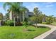 Beautifully landscaped front yard with lush green grass and mature tropical trees at 843 Christina Chase Dr, Lakeland, FL 33813