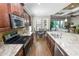 Modern kitchen featuring stainless steel appliances, granite counters, and an open dining area at 843 Christina Chase Dr, Lakeland, FL 33813