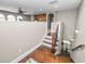 A landing showcases hardwood floors and stairs leading up to an open living area with a glimpse of the kitchen at 843 Christina Chase Dr, Lakeland, FL 33813