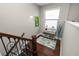 A landing showcases hardwood floors, stylish console table and decor, and a black, ornate railing at 843 Christina Chase Dr, Lakeland, FL 33813
