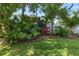 Lush landscaping with vibrant plants, mature trees, and manicured lawn, enhancing the property's curb appeal at 843 Christina Chase Dr, Lakeland, FL 33813