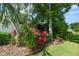 Exquisite landscaping featuring lush greenery, colorful plants, and mature trees, creating a serene outdoor space at 843 Christina Chase Dr, Lakeland, FL 33813