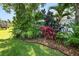 Beautifully landscaped backyard with vibrant tropical plants, adding color and privacy at 843 Christina Chase Dr, Lakeland, FL 33813
