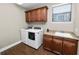 Laundry room features wood look floors and sink at 843 Christina Chase Dr, Lakeland, FL 33813