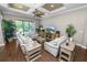Spacious living room with stylish furniture, hardwood floors, and large windows overlooking the backyard oasis at 843 Christina Chase Dr, Lakeland, FL 33813