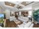 Bright living room featuring hardwood floors and a unique coffered ceiling with a fan at 843 Christina Chase Dr, Lakeland, FL 33813