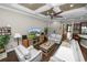 Comfortable living room features hardwood floors, a decorative ceiling fan, and easy access to other areas of the home at 843 Christina Chase Dr, Lakeland, FL 33813
