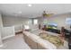 An upper-level living area is carpeted with a ceiling fan, sofa, desk, and entertainment center at 843 Christina Chase Dr, Lakeland, FL 33813