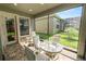 Cozy screened patio with brick flooring and glass table, perfect for enjoying outdoor meals at 843 Christina Chase Dr, Lakeland, FL 33813