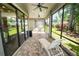 Inviting screened patio with brick flooring, ceiling fans, and lounge seating, perfect for outdoor relaxation at 843 Christina Chase Dr, Lakeland, FL 33813