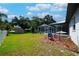 Expansive backyard featuring a screened-in pool, storage shed, and well-maintained lawn at 8760 Plantation Ridge Blvd, Lakeland, FL 33809