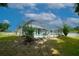 Expansive backyard showcasing the screened-in pool area with manicured lawn and mature trees at 8760 Plantation Ridge Blvd, Lakeland, FL 33809