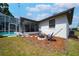 Charming backyard featuring a fire pit, hammock, and access to the screened-in pool area at 8760 Plantation Ridge Blvd, Lakeland, FL 33809