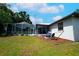 Spacious backyard with a screened-in pool, fire pit area, and lush green lawn at 8760 Plantation Ridge Blvd, Lakeland, FL 33809