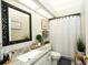 Clean and updated bathroom features a granite countertop, a framed mirror, and a shower with a curtain at 8760 Plantation Ridge Blvd, Lakeland, FL 33809