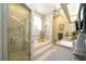 Soaking tub with tile surround, shower, and double sinks in this luxurious primary bathroom at 8760 Plantation Ridge Blvd, Lakeland, FL 33809