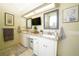 Bright bathroom featuring dual sinks, large vanity, granite countertops, and decorative mirrors at 8760 Plantation Ridge Blvd, Lakeland, FL 33809