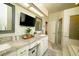 Bathroom with granite countertops, double sinks, vanity, tile floors, and glass shower at 8760 Plantation Ridge Blvd, Lakeland, FL 33809